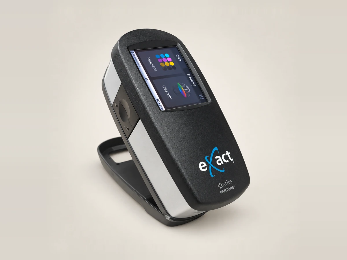 X-Rite eXact handheld spectrophotometer on its stand, showing its colour screen